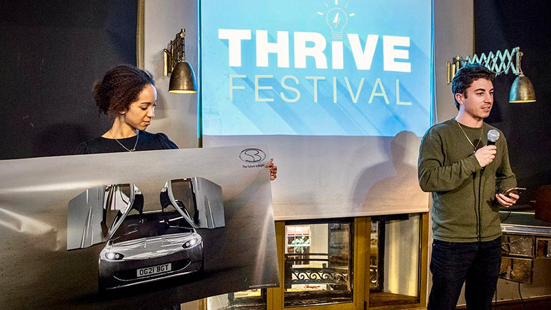Two people on a stage at thrive festival